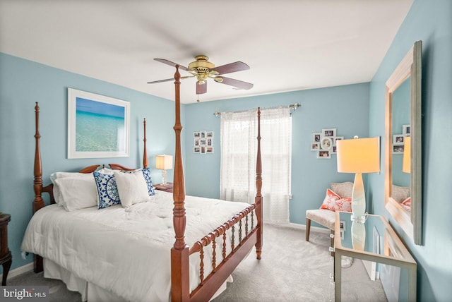 carpeted bedroom with a ceiling fan and baseboards