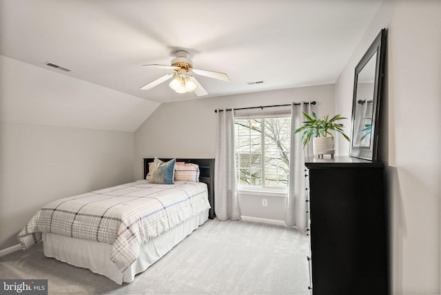 bedroom with light carpet, baseboards, visible vents, and lofted ceiling