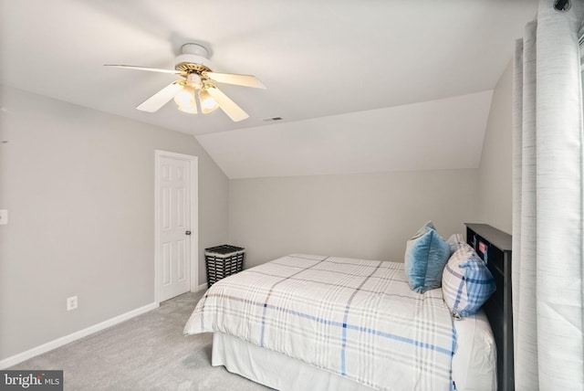 bedroom featuring carpet floors, visible vents, a ceiling fan, vaulted ceiling, and baseboards