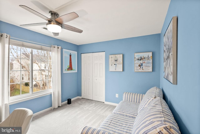 interior space featuring a ceiling fan, carpet flooring, plenty of natural light, and baseboards