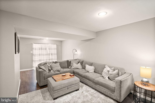 living room featuring wood finished floors and baseboards