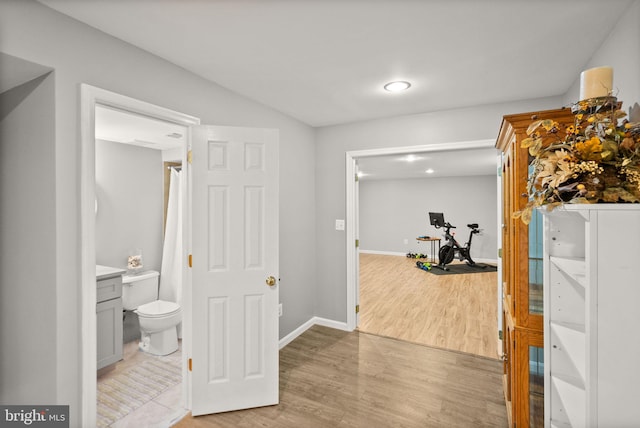 workout room with light wood finished floors and baseboards