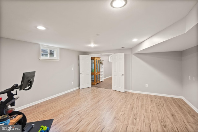 exercise area with recessed lighting, light wood-type flooring, and baseboards