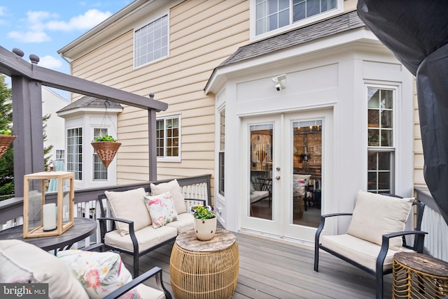 wooden terrace with an outdoor hangout area and french doors