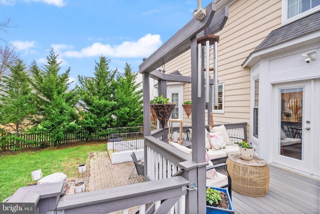 deck featuring fence and a yard