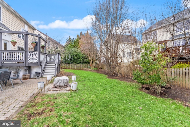 view of yard with a patio area, a fenced backyard, and a wooden deck