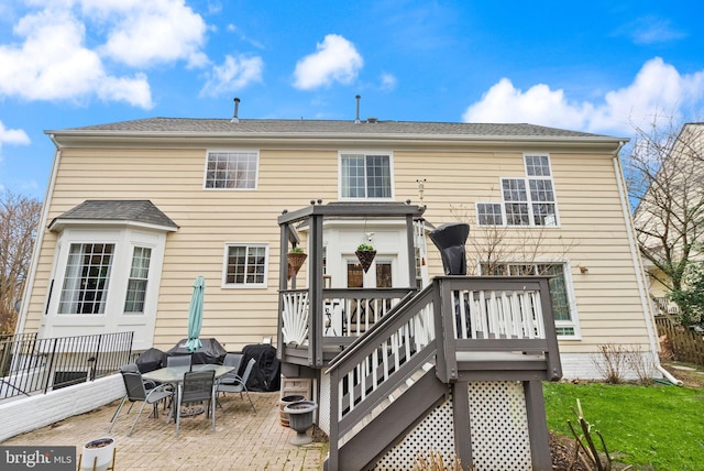 back of house with a wooden deck, a fire pit, a patio, stairway, and a yard