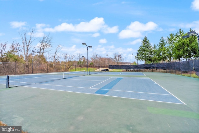 view of sport court featuring fence