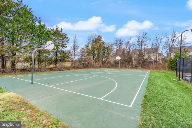 view of basketball court featuring community basketball court and a lawn