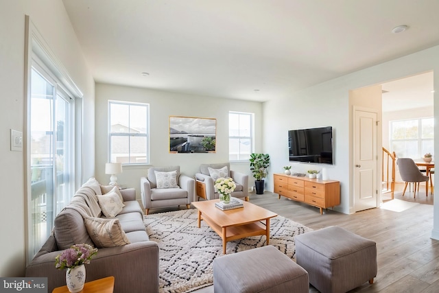 305 Poplar Ave, Newark, DE 19711 - living area with light wood-type flooring and a healthy amount of sunlight