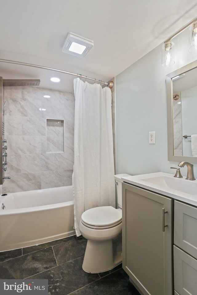 full bath with vanity, toilet, and shower / bath combo