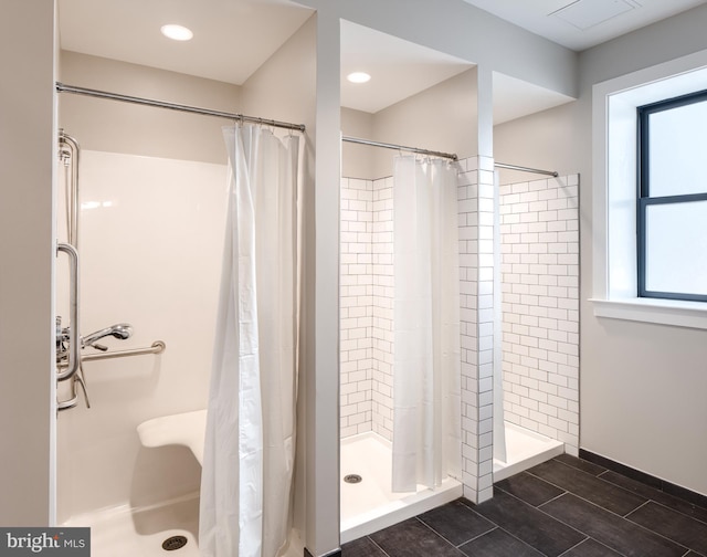 bathroom with a stall shower and recessed lighting