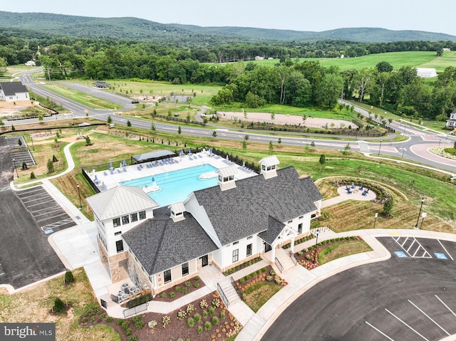 drone / aerial view with a wooded view