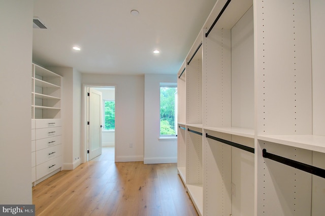 spacious closet featuring light wood-type flooring and visible vents