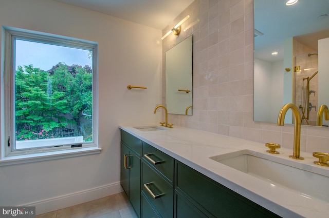 full bath featuring plenty of natural light, tile patterned flooring, and a sink