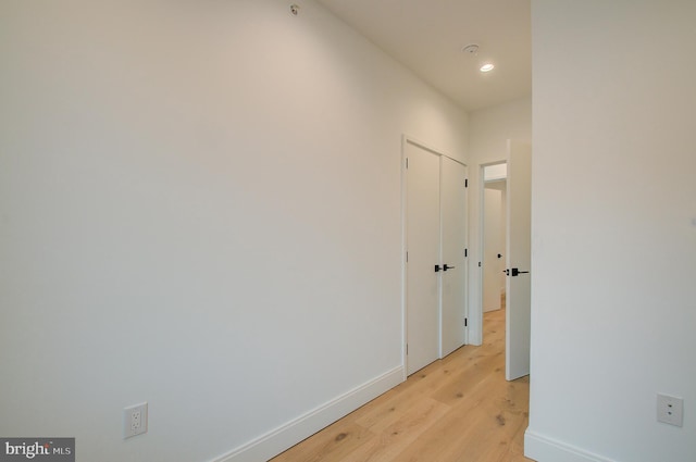 corridor featuring recessed lighting, light wood-type flooring, and baseboards