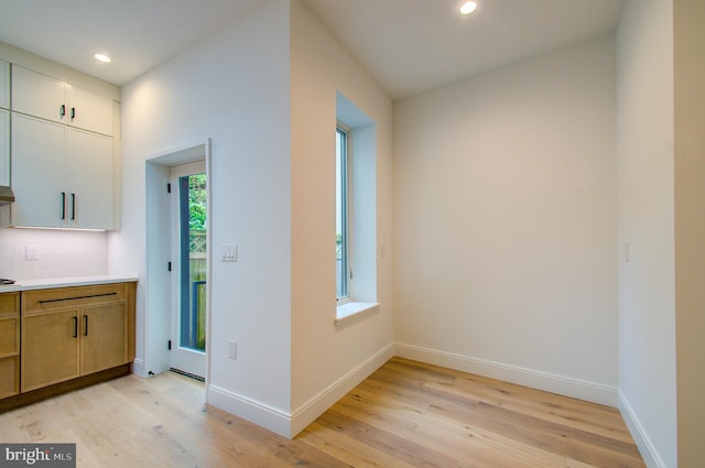 interior space featuring light wood-type flooring, baseboards, and recessed lighting