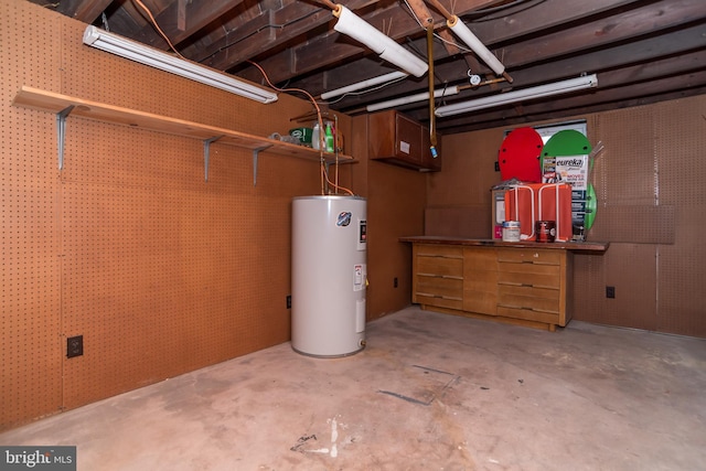 unfinished basement featuring water heater and a workshop area