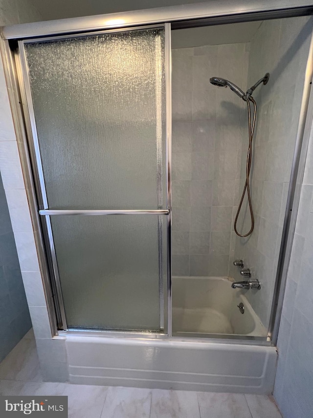 full bathroom featuring bath / shower combo with glass door