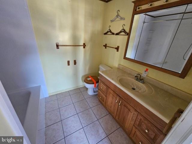 full bathroom featuring toilet, vanity, walk in shower, and tile patterned floors