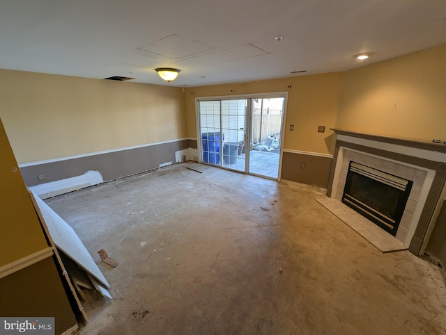 unfurnished living room featuring a fireplace and concrete floors