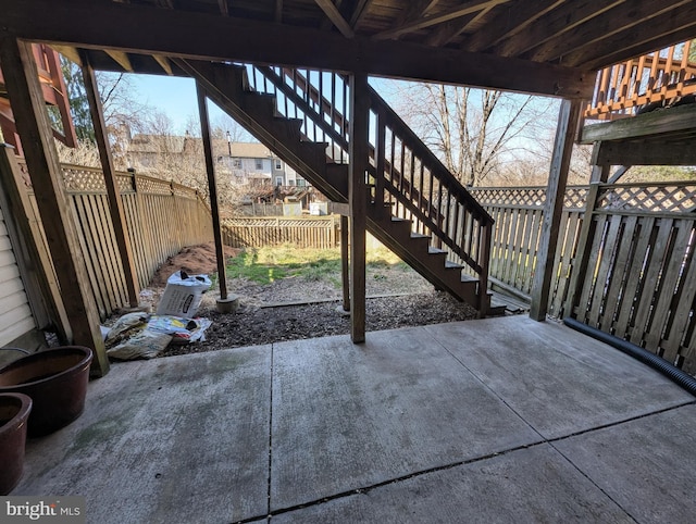 view of patio / terrace with stairway and fence