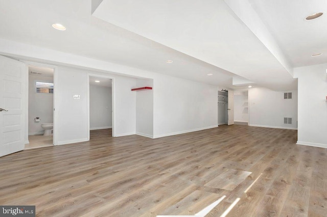 unfurnished living room featuring recessed lighting, baseboards, visible vents, and light wood finished floors