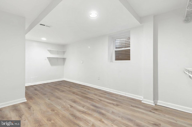 finished basement featuring visible vents, recessed lighting, light wood-type flooring, and baseboards