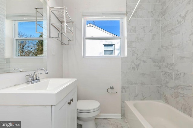 bathroom featuring a wealth of natural light, toilet, marble finish floor, and vanity