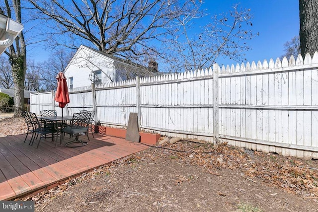 view of patio / terrace featuring outdoor dining space, a wooden deck, and fence