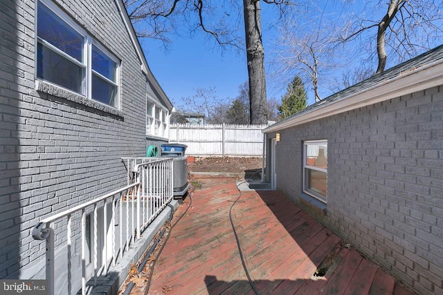 wooden deck featuring fence and central AC