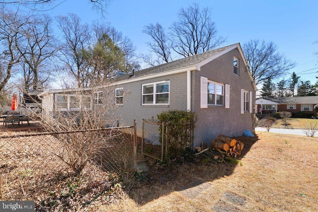 exterior space featuring brick siding and fence