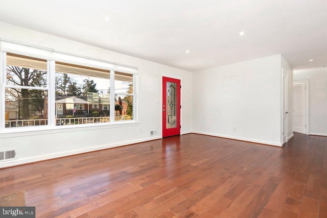 interior space with recessed lighting, wood finished floors, visible vents, and baseboards