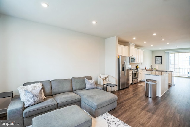 living room with dark wood finished floors and recessed lighting