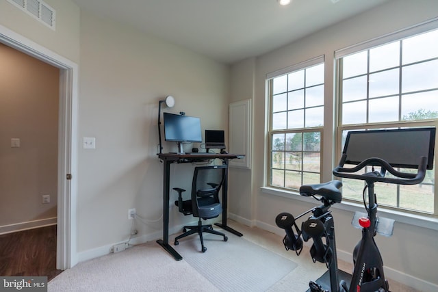 exercise room featuring baseboards and visible vents