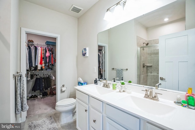 full bath with double vanity, a sink, visible vents, and a shower stall