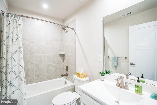 full bath with toilet, vanity, shower / bath combo with shower curtain, and visible vents