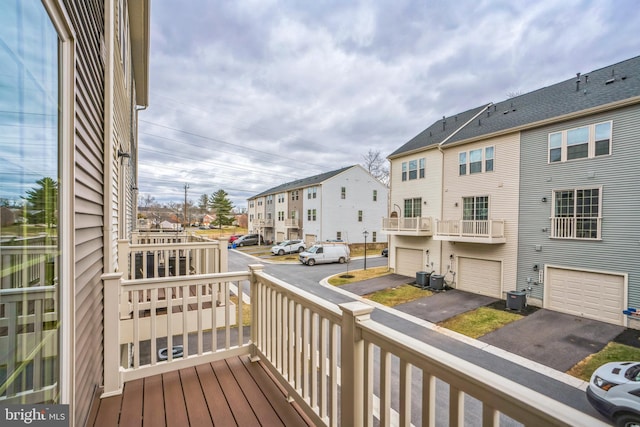 balcony with a residential view and central AC unit