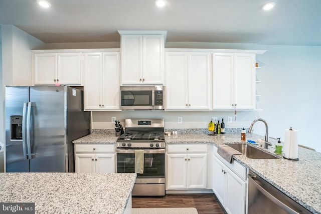 kitchen featuring recessed lighting, a sink, white cabinetry, appliances with stainless steel finishes, and dark wood-style floors