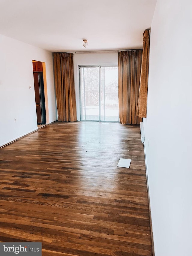 empty room featuring dark wood-type flooring