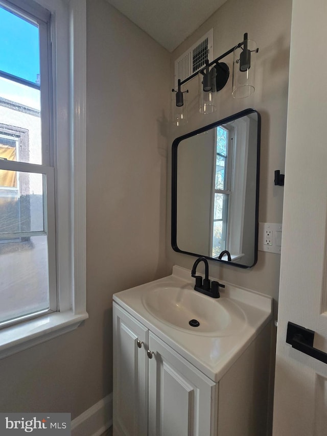 bathroom featuring plenty of natural light and vanity