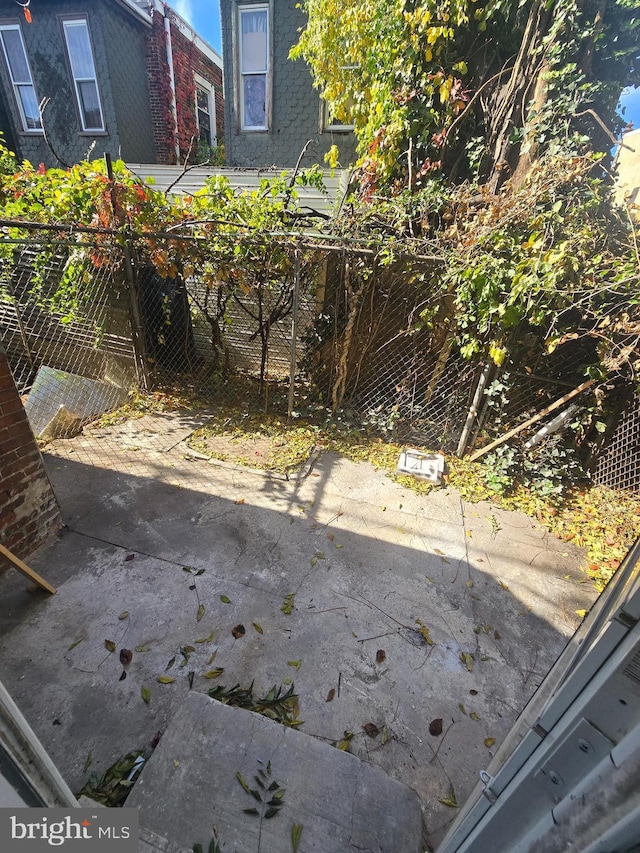 view of patio featuring fence