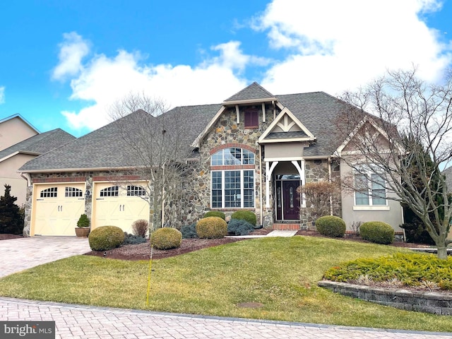 view of front of property with a garage, stone siding, stucco siding, decorative driveway, and a front yard