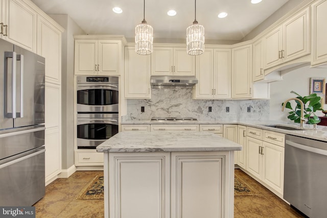 kitchen featuring under cabinet range hood, tasteful backsplash, appliances with stainless steel finishes, and a sink