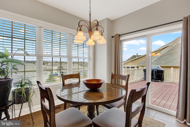 dining room featuring a chandelier and baseboards