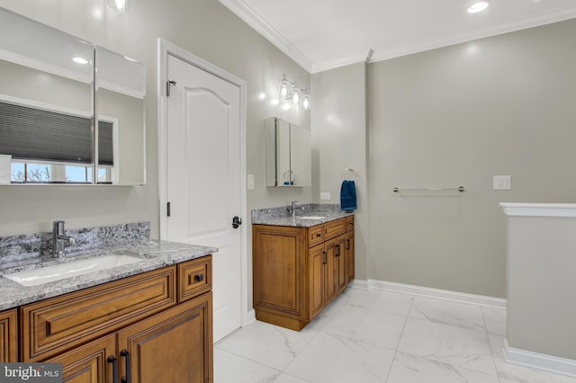 bathroom featuring marble finish floor, ornamental molding, a sink, and baseboards