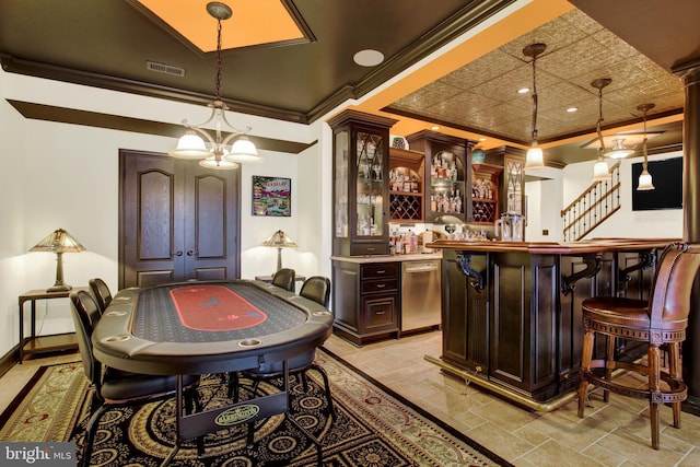 bar with crown molding, hanging light fixtures, bar, dishwasher, and baseboards