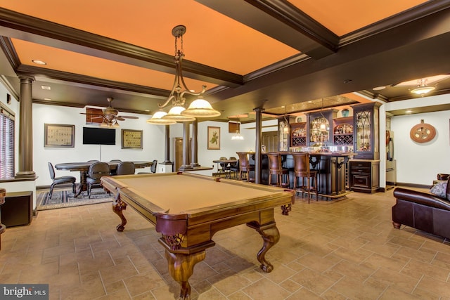 playroom featuring decorative columns, baseboards, ceiling fan, stone finish floor, and a bar