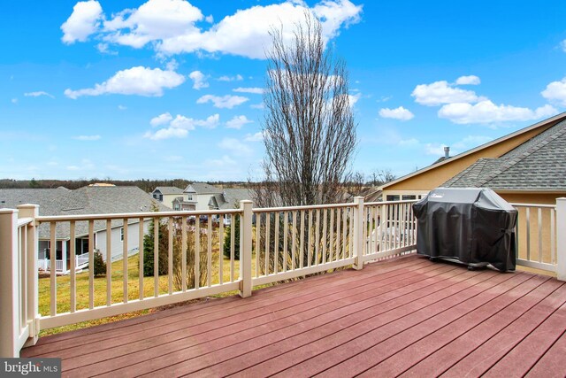 wooden deck featuring a residential view and grilling area