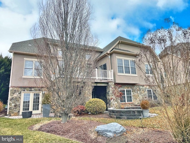 view of front of home with stone siding and stucco siding